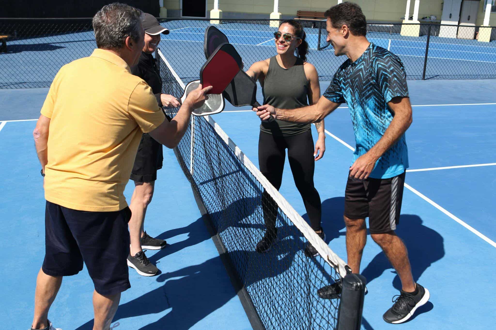 the importance of community discussed by Dr. Kavin Mistry is depicted in this image of friends playing tennis.